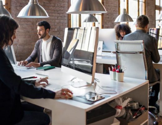 small business employees work in an open office